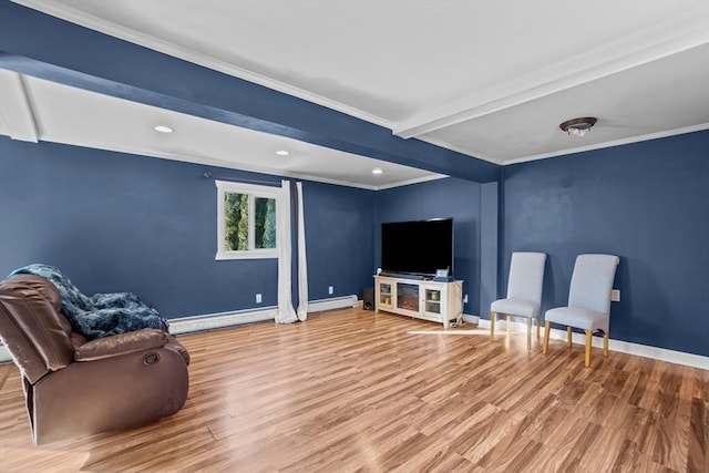 sitting room with a baseboard heating unit, beamed ceiling, crown molding, and hardwood / wood-style floors