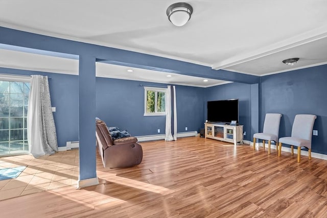 living room with baseboard heating, beam ceiling, and light wood-type flooring