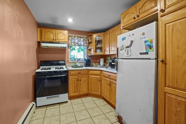 kitchen with light tile patterned floors, sink, white appliances, and a baseboard radiator