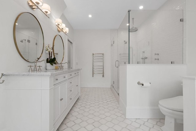 full bath with double vanity, a stall shower, toilet, recessed lighting, and baseboards