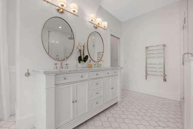 full bath featuring double vanity, baseboards, and an enclosed shower