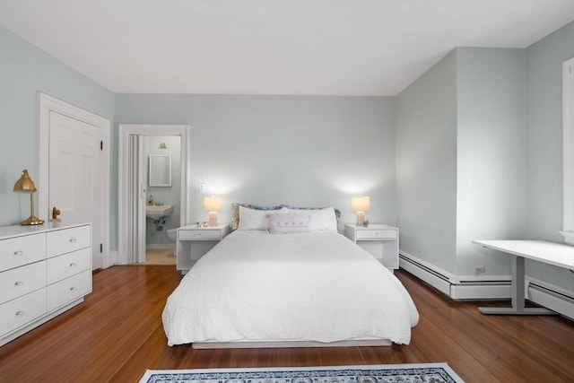 bedroom with wood finished floors and baseboards