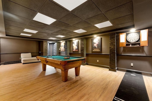 recreation room with a paneled ceiling, wood finished floors, billiards, baseboards, and a baseboard radiator