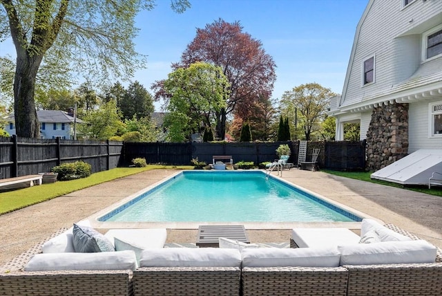 view of swimming pool with outdoor lounge area, a patio area, and a fenced backyard