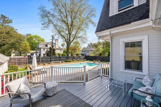 wooden deck with a fenced backyard