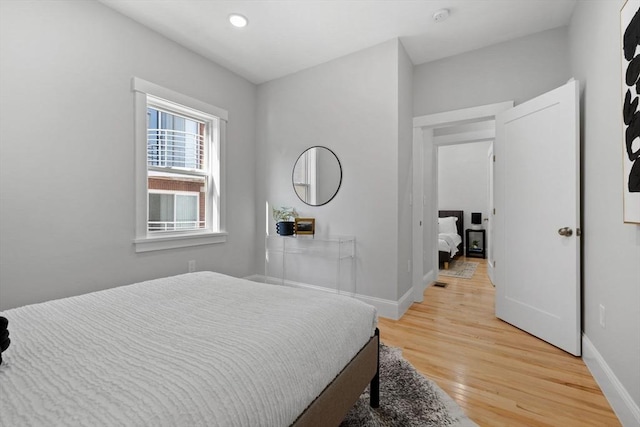 bedroom featuring recessed lighting, baseboards, and light wood finished floors