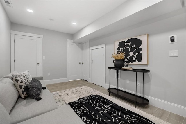 entrance foyer featuring baseboards, visible vents, wood finished floors, and recessed lighting