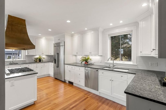 kitchen featuring white cabinets, light wood finished floors, and appliances with stainless steel finishes