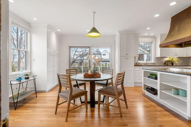 dining room with recessed lighting and light wood-style flooring