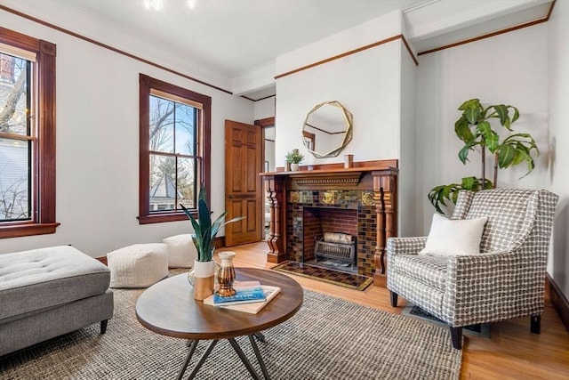 sitting room with light wood-style floors and ornamental molding