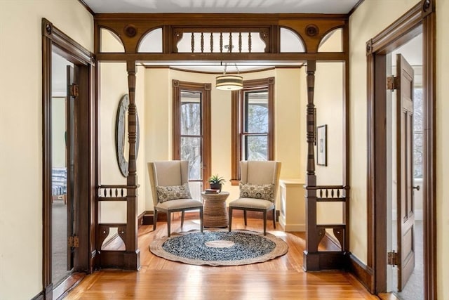 sitting room with light wood-type flooring and baseboards