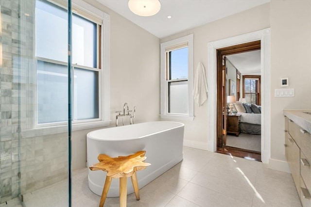 bathroom with vanity, tiled shower, a soaking tub, tile patterned flooring, and ensuite bathroom