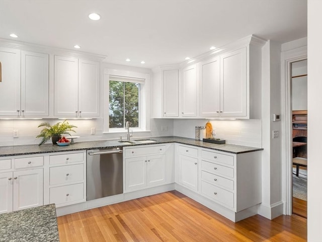 kitchen featuring white cabinets, dishwasher, light wood-style flooring, and a sink