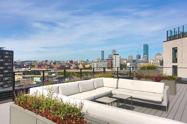 wooden deck featuring outdoor lounge area and a view of city