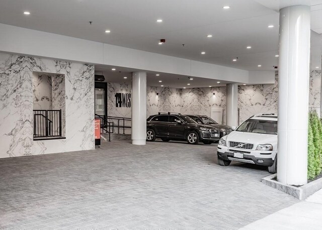 garage with stone wall and recessed lighting
