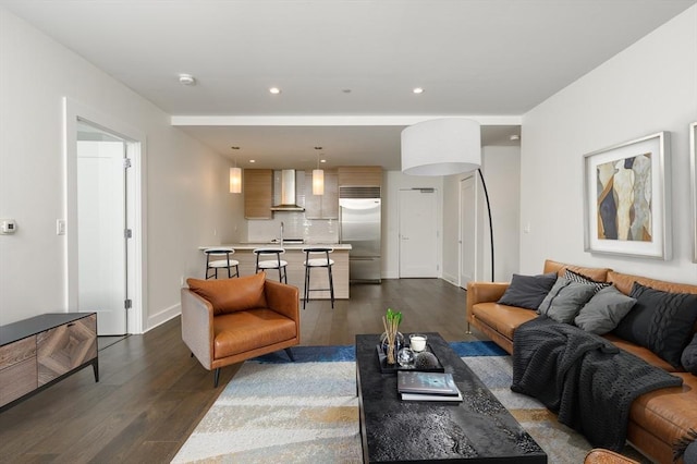 living room featuring recessed lighting, dark wood finished floors, and baseboards