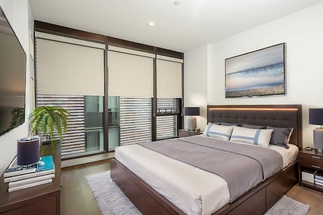 bedroom featuring wood finished floors and recessed lighting
