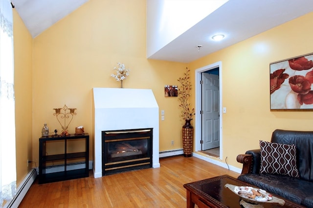 living room with lofted ceiling, light wood-type flooring, and a baseboard heating unit