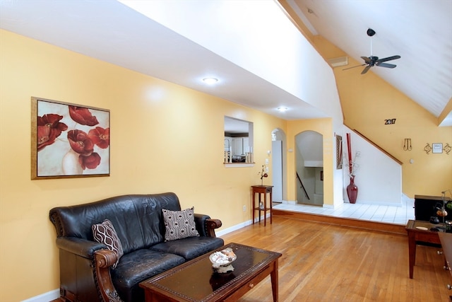 living room featuring light wood-type flooring, high vaulted ceiling, and ceiling fan