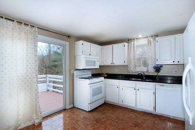 kitchen featuring sink, white cabinets, and white appliances