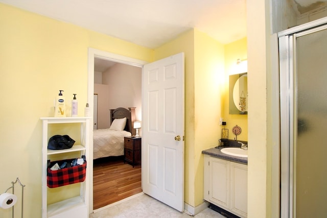 bathroom with vanity, hardwood / wood-style flooring, and an enclosed shower