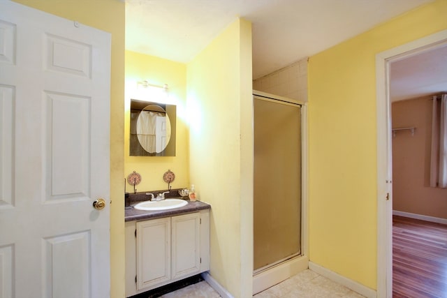 bathroom featuring vanity, wood-type flooring, and walk in shower