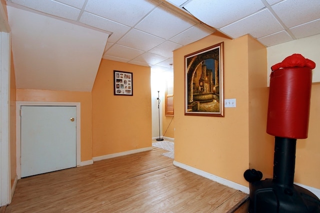 corridor featuring hardwood / wood-style floors and a paneled ceiling