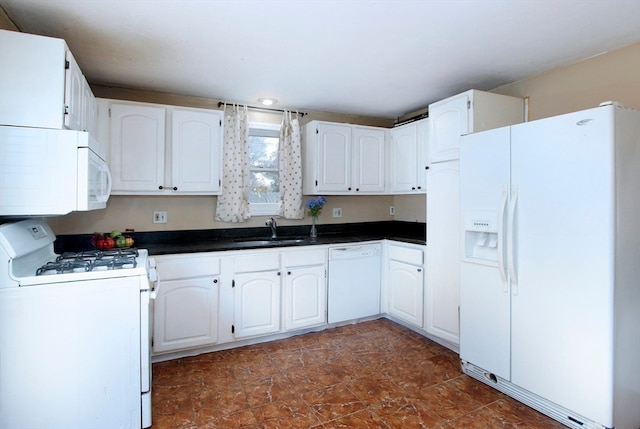 kitchen featuring white appliances, white cabinetry, and sink