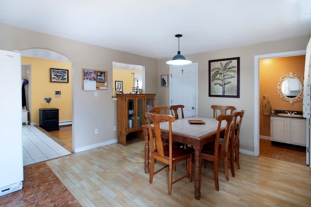 dining room featuring sink and light wood-type flooring