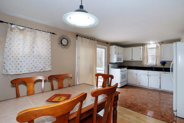 dining area with light hardwood / wood-style floors and sink