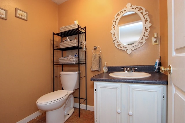 bathroom featuring tile patterned flooring, vanity, and toilet