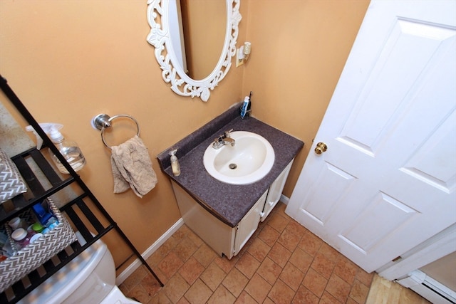 bathroom with vanity, toilet, and a baseboard radiator