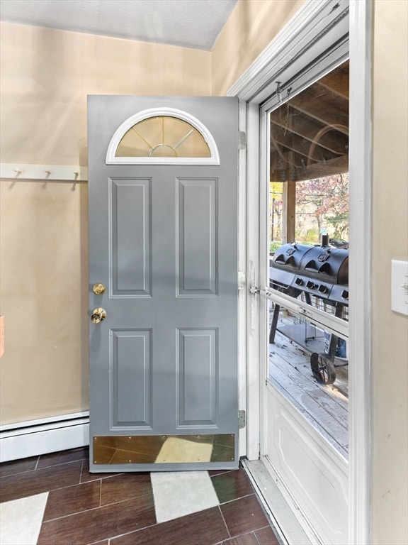 interior space featuring baseboard heating and dark hardwood / wood-style flooring