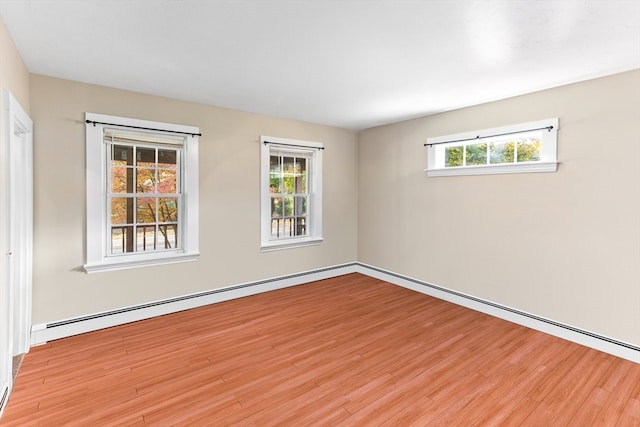 spare room featuring light hardwood / wood-style floors and a wealth of natural light