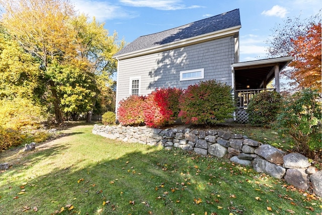 view of side of home featuring a yard