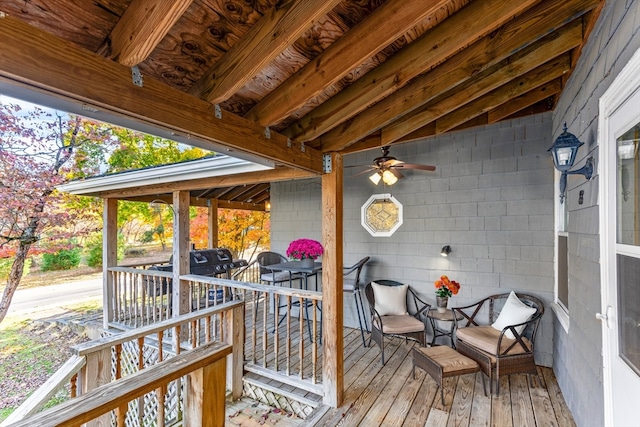 wooden deck featuring ceiling fan