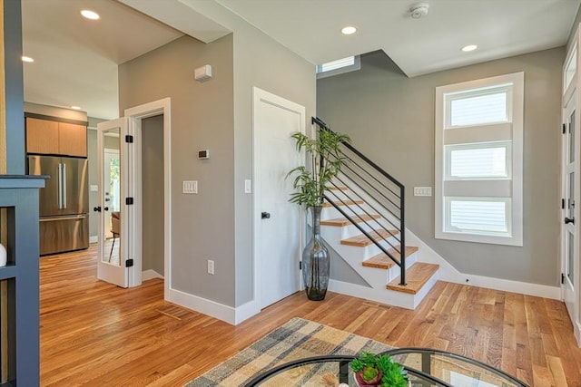 238 Sycamore St Unit 238, Watertown, MA 02472 - foyer entrance with light wood-style floors, baseboards, stairs, and recessed lighting