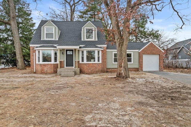 cape cod home featuring a garage