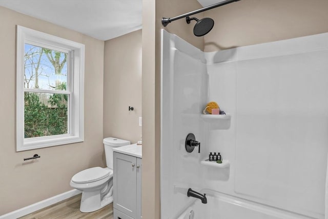 full bathroom with hardwood / wood-style flooring, vanity, toilet, and a wealth of natural light