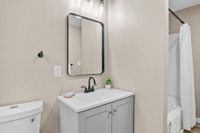 full bathroom featuring vanity, toilet, and shower / tub combo with curtain