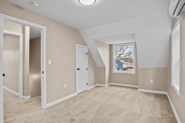 additional living space featuring an AC wall unit, light carpet, and vaulted ceiling