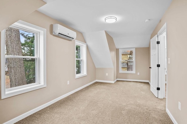 additional living space with light colored carpet, vaulted ceiling, and a wall mounted AC