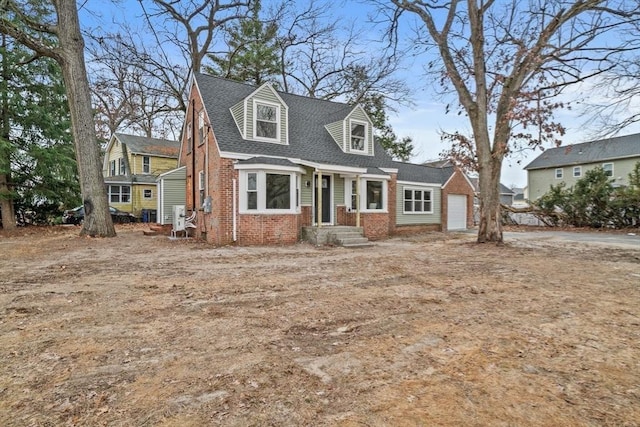 cape cod-style house featuring a garage