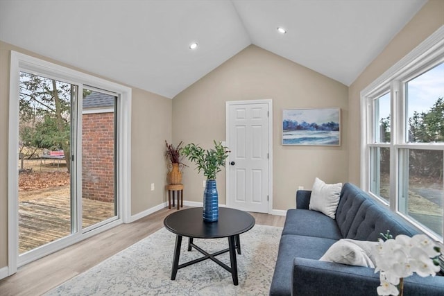 living room featuring lofted ceiling and light wood-type flooring