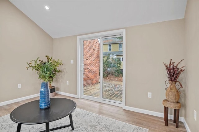 entryway with light wood-type flooring and vaulted ceiling