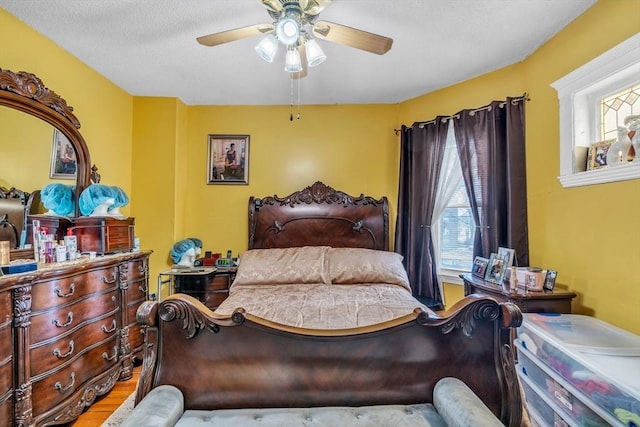 bedroom featuring wood finished floors and a ceiling fan