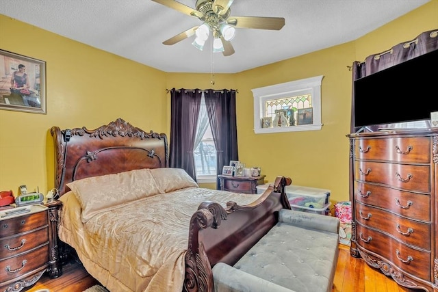 bedroom with a ceiling fan and wood finished floors