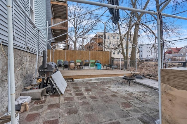 view of patio / terrace featuring a fire pit, a grill, fence private yard, and a deck