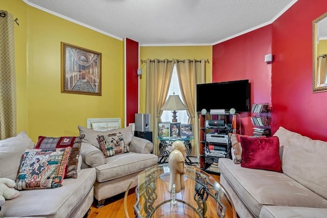 living room with a textured ceiling, wood finished floors, and crown molding