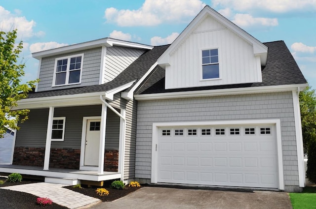 27 Willow Pond Cir Unit 27, Medway, MA 02053 - view of front facade featuring a porch, driveway, roof with shingles, and board and batten siding
